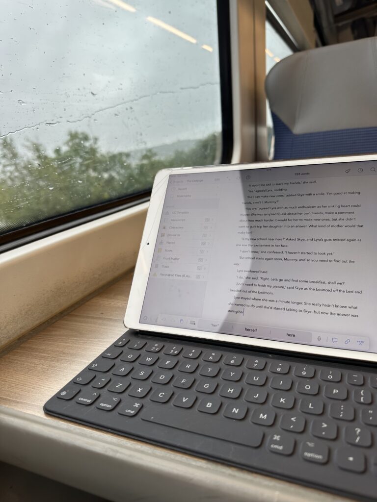 Photo shows an iPad on a train table. 