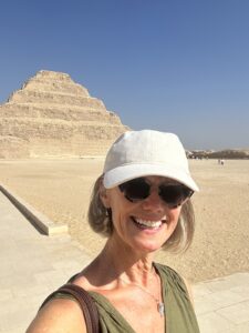 Image shows author Imogen Clark in front of a pyramid